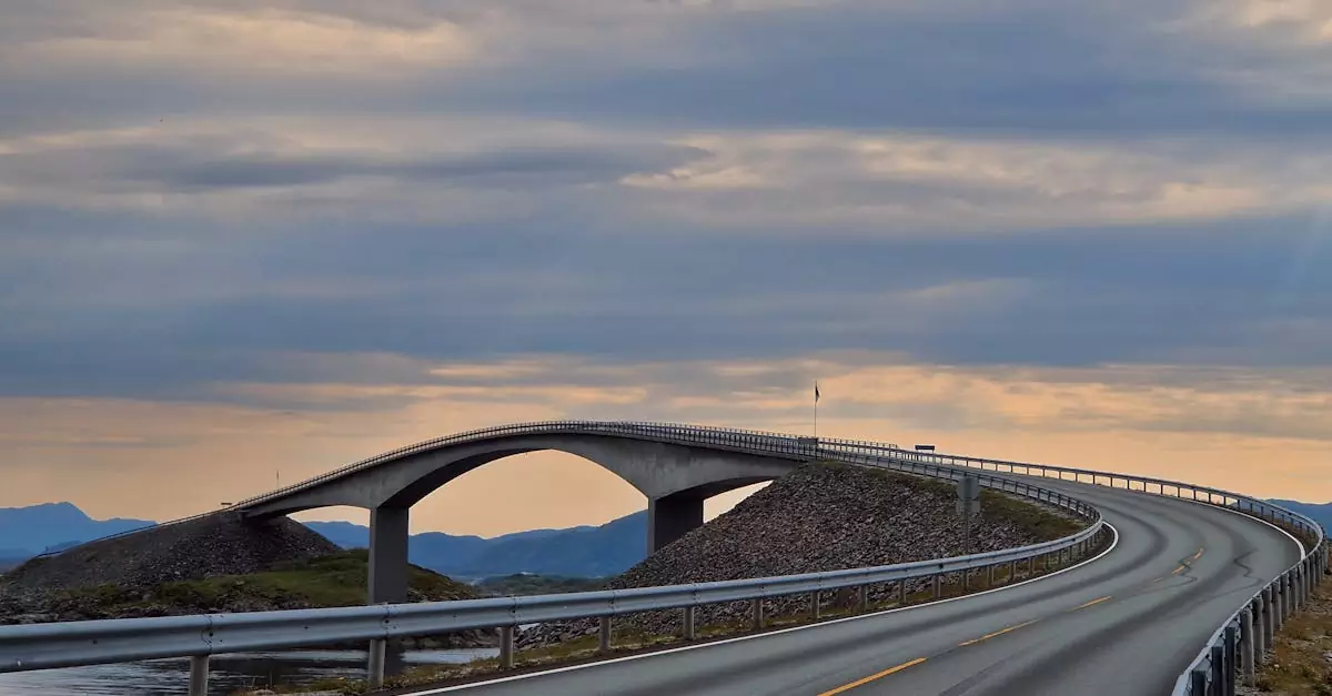 A captivating view of the Atlantic Ocean Road bridge in Norway during a serene sunset, showcasing stunning coastal scenery.