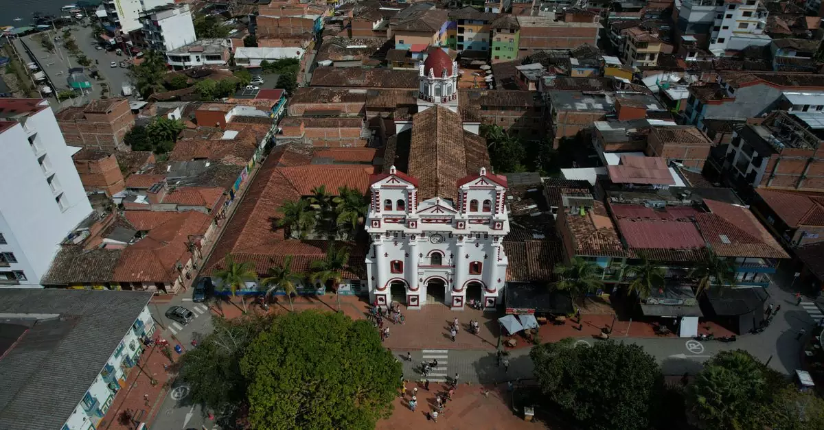 Drone capture of Guatap&eacute;'s iconic church and surrounding townscape in Colombia.