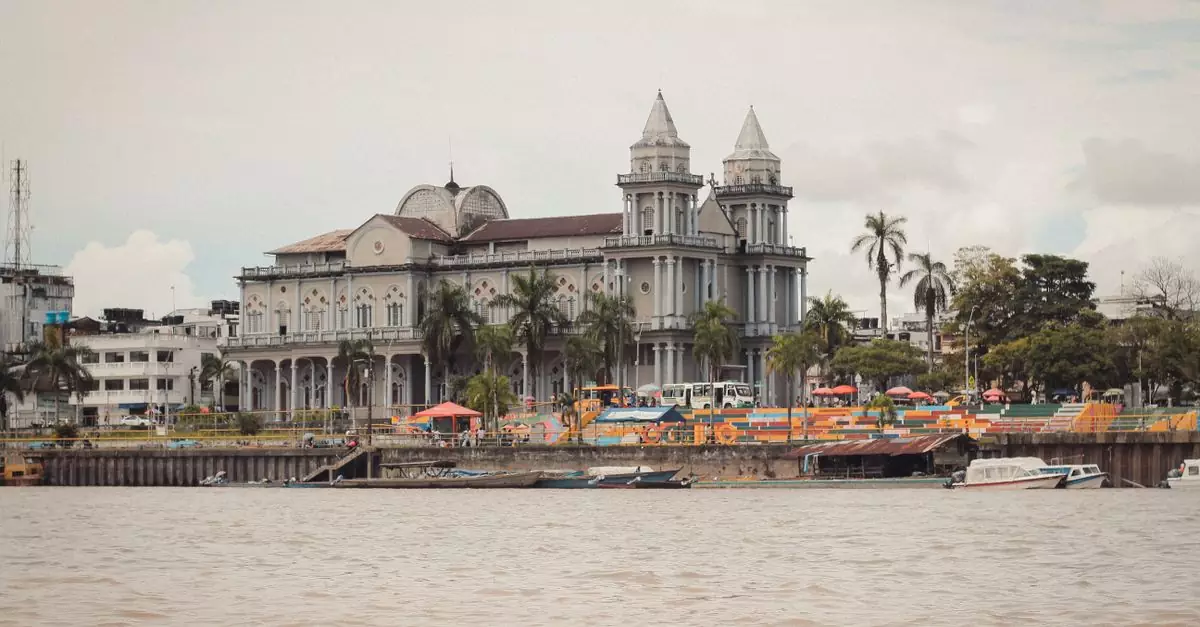 A picturesque view of a historic cathedral along the riverfront in Quibd&oacute;, showcasing stunning architecture.