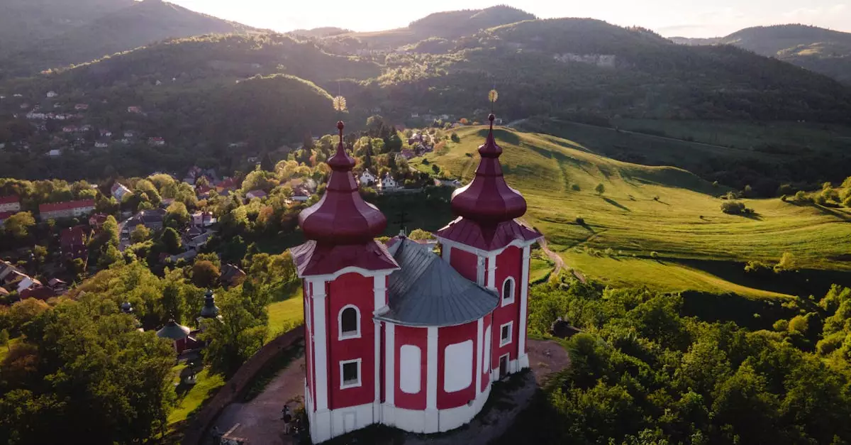 Aerial view of Bansk&aacute; &Scaron;tiavnica's famous Kalv&aacute;ria against lush landscapes.
