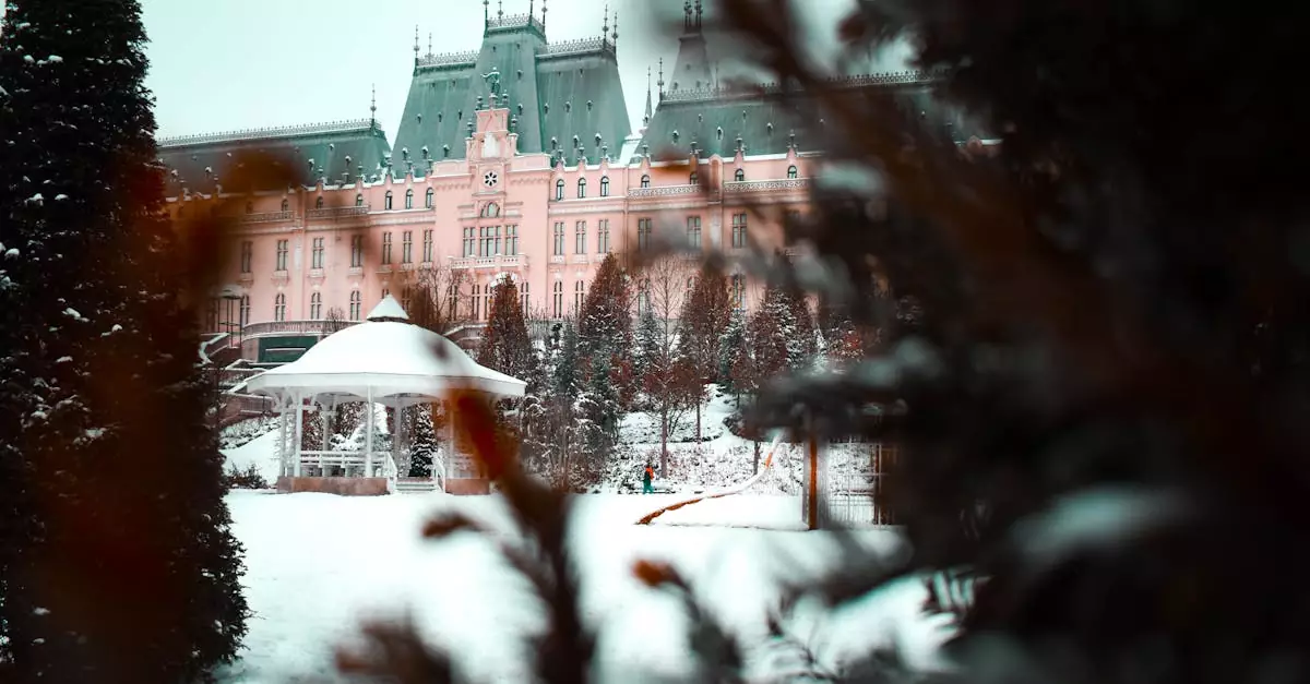 A stunning winter scene of a historic palace framed by snow-covered trees and a gazebo in a scenic park.