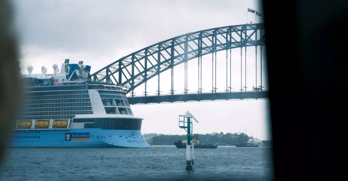 Cruise ship sailing under the iconic Sydney Harbor Bridge on a cloudy day.