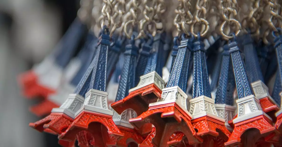 Close-up of Eiffel Tower souvenir keychains in Paris, France, emphasizing abundance and vibrant colors.