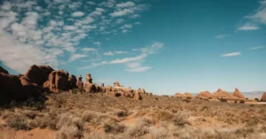 Stunning landscape of Arches National Park with iconic red rock formations under a clear blue sky.