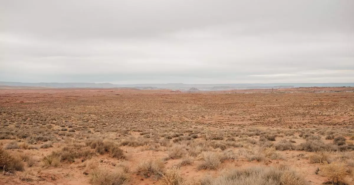 Expansive arid desert landscape with cloudy skies in Arizona, USA.