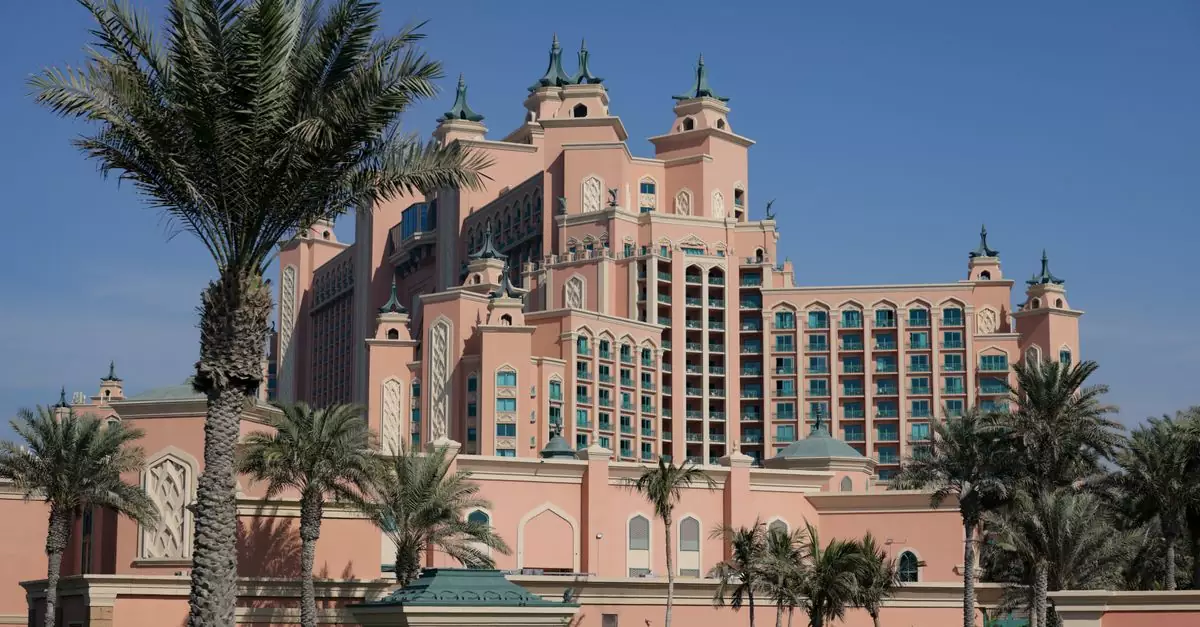Majestic modern Atlantis hotel architecture with palm trees under a clear blue sky.