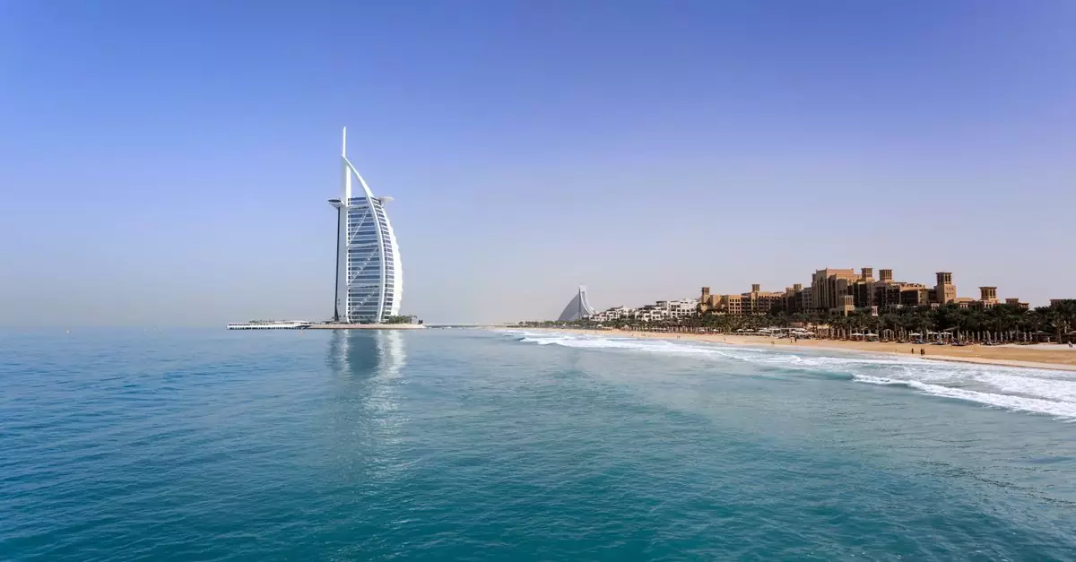 Iconic Burj Al Arab overlooking the pristine Dubai beach, perfect for travel and leisure.