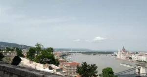 A breathtaking aerial view of Budapest showcases the Danube River and iconic landmarks like the Hungarian Parliament.