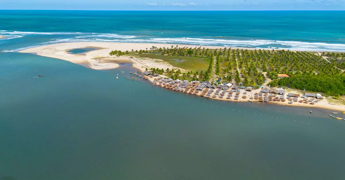 A stunning aerial view of a tropical beach resort in Jandaíra, Brazil, showcasing serene ocean waters.
