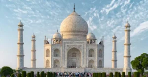 Explore the iconic Taj Mahal, a UNESCO World Heritage Site in Agra, India, captured under a bright blue sky.