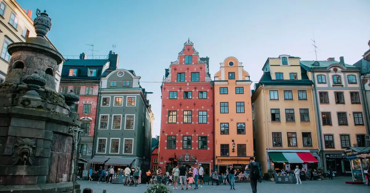 Vibrant buildings and bustling atmosphere in Stockholm's historic Gamla Stan square.