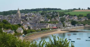 A picturesque view of the charming village of Saint-Suliac in Bretagne, France, overlooking the coast.