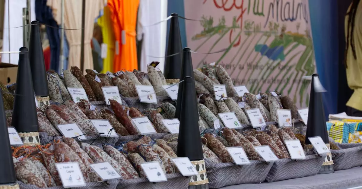 Colorful market stall in Dinard, France showcasing a variety of artisan sausages.