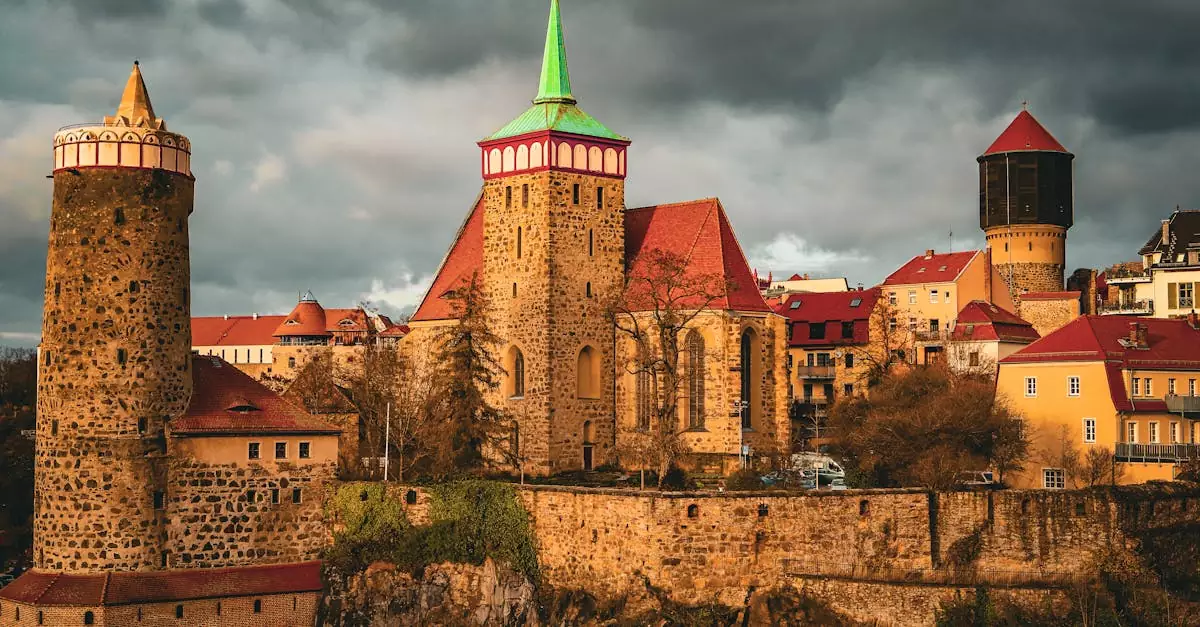 Dramatic skyline of Bautzen's medieval architecture, featuring St. Michael's Church and city walls under dark clouds.