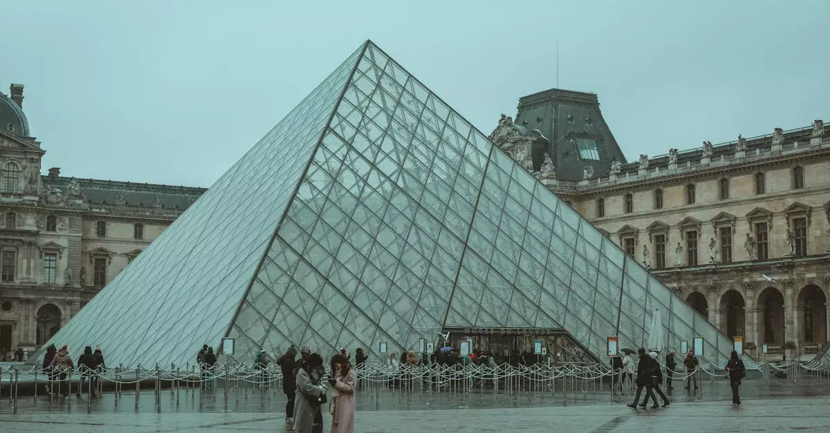 A winter day at the iconic Louvre Museum pyramid in Paris, capturing tourists and the architectural beauty.