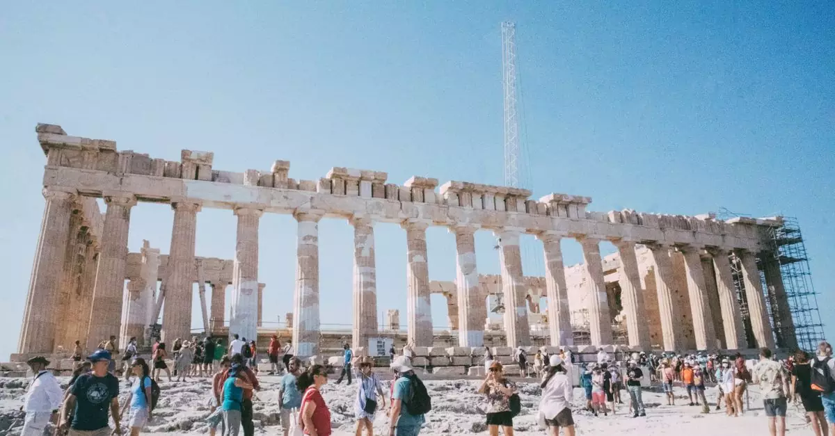 Visitors admire the historic Parthenon in Athens, a key UNESCO World Heritage site.