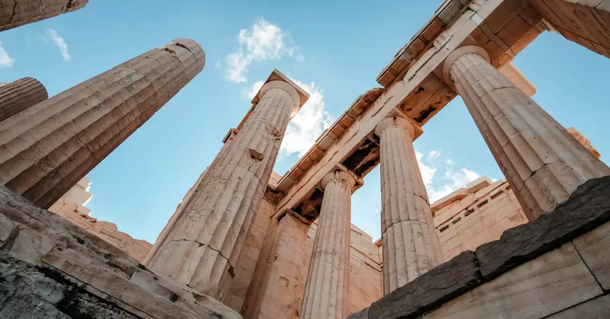 Low angle view of ancient Parthenon columns in Athens, Greece, highlighting classical architecture under a clear sky.