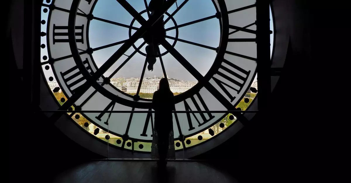 A silhouette of a person standing by the iconic Musee d'Orsay clock in Paris.