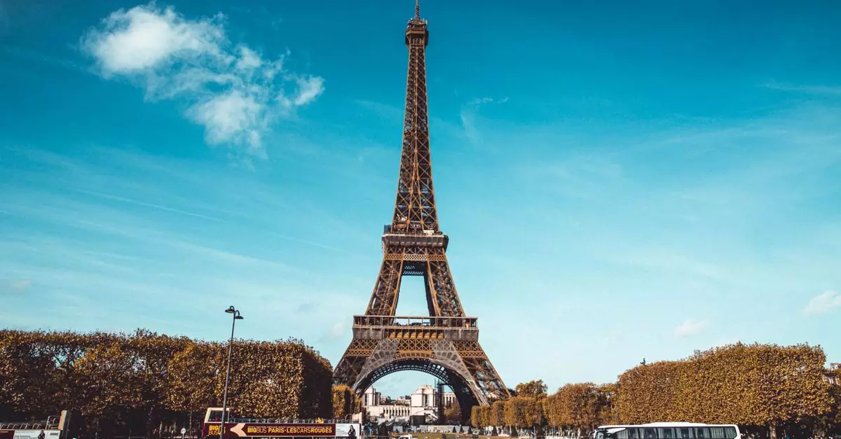 Stunning view of the Eiffel Tower in Paris under a clear blue sky, capturing the iconic landmark.