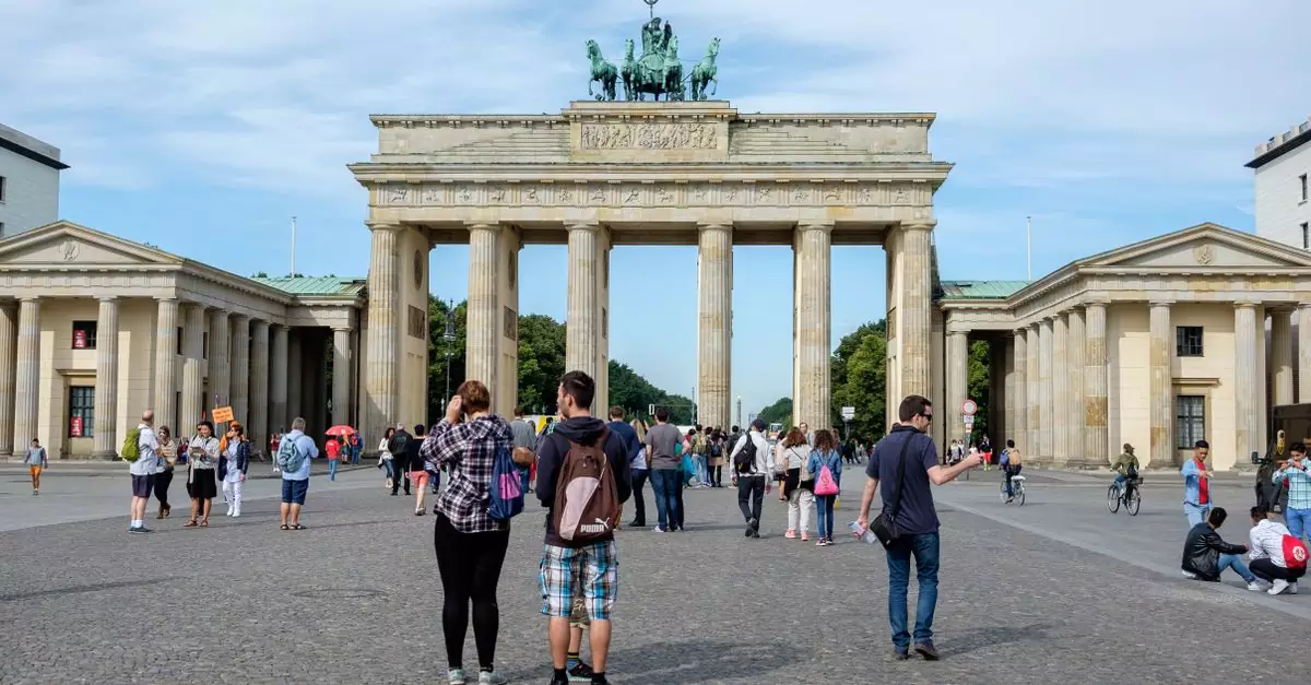 Visitors explore the iconic Brandenburg Gate in Berlin, Germany.