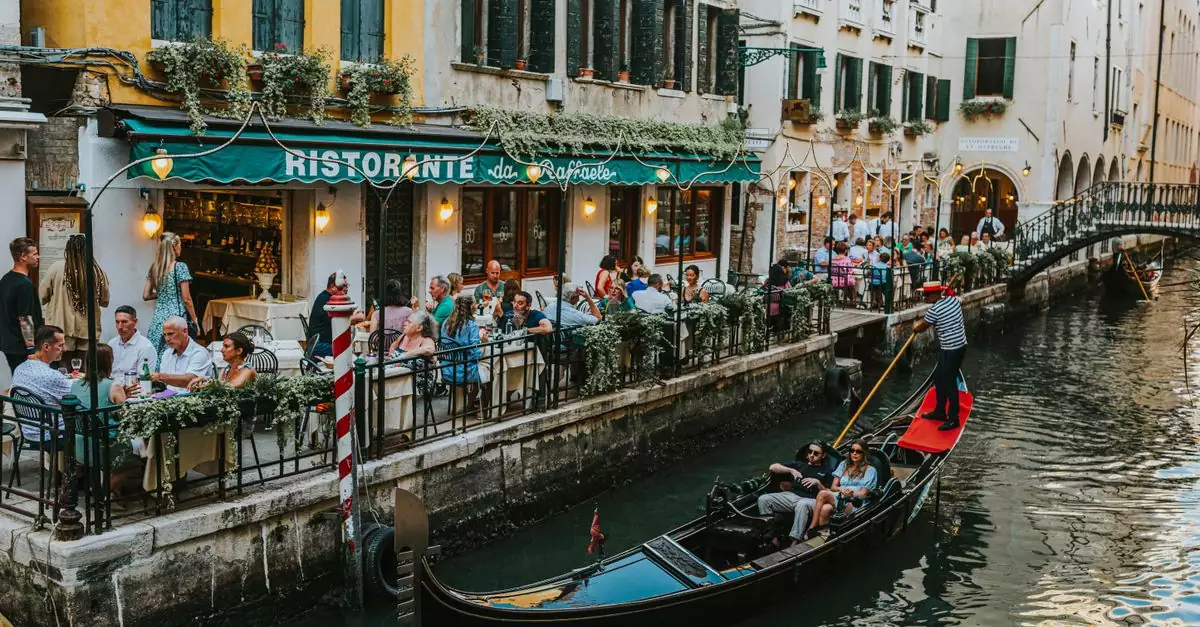Charming dining scene along a Venetian canal with gondolas and bustling restaurants.
