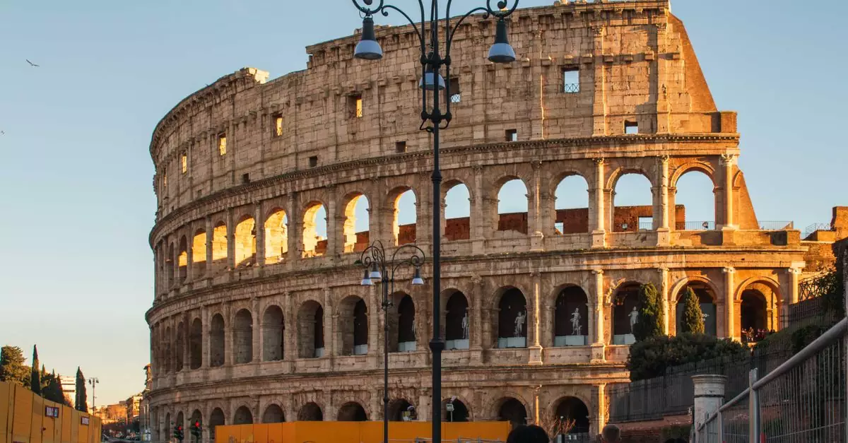 Busy street scene at Rome's Colosseum during sunset, highlighting ancient Roman architecture and vibrant city life.