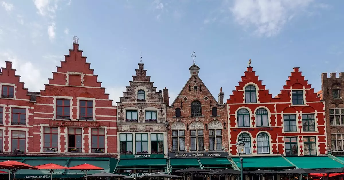 Charming gabled townhouses in Bruges Market Square, showcasing vibrant architecture and bustling atmosphere.