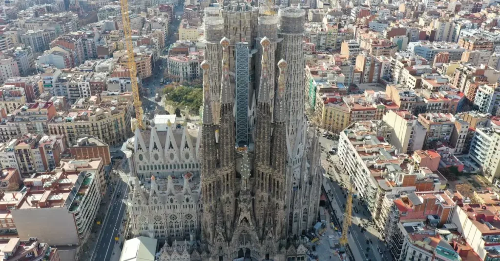 Best Food Cities in Spain: A Culinary Guide 2 Stunning aerial shot of the iconic Sagrada Familia cathedral in Barcelona, showcasing its intricate architecture and surrounding urban landscape.