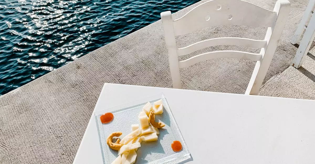 Serene seaside setting in Greece with a glass plate of Greek snacks next to sparkling water.
