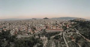 A stunning aerial view of Athens cityscape at sunrise, showcasing historical landmarks.