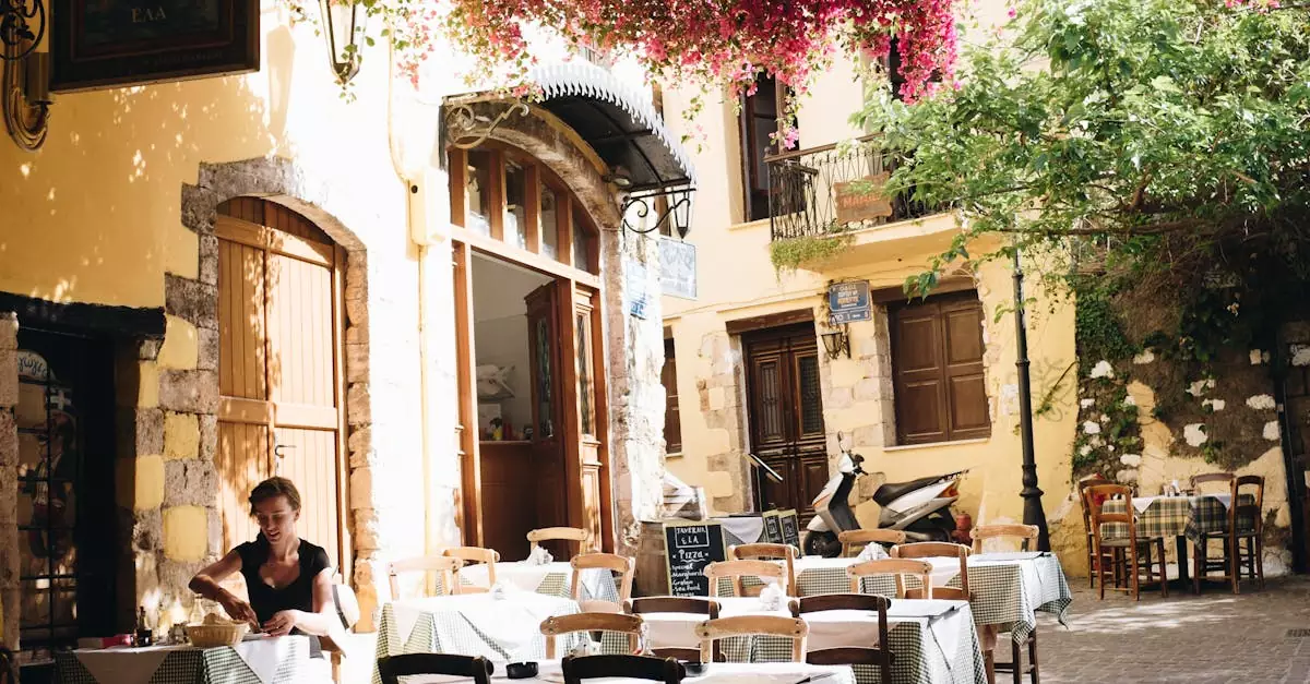 A quiet outdoor cafe in Chania, Greece, under sunlight and vibrant flowers.