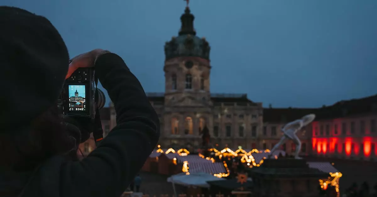 A photographer captures a historic landmark with festive lights at twilight.
