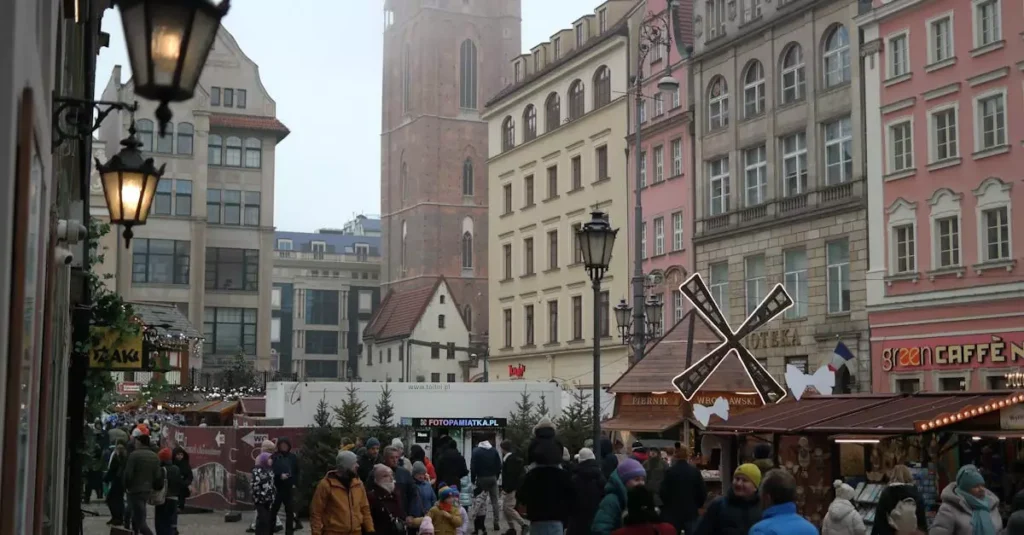 Best Food Festivals in Europe: A Culinary Guide 2 A bustling winter market in a historic European city with colorful buildings and lively crowd.