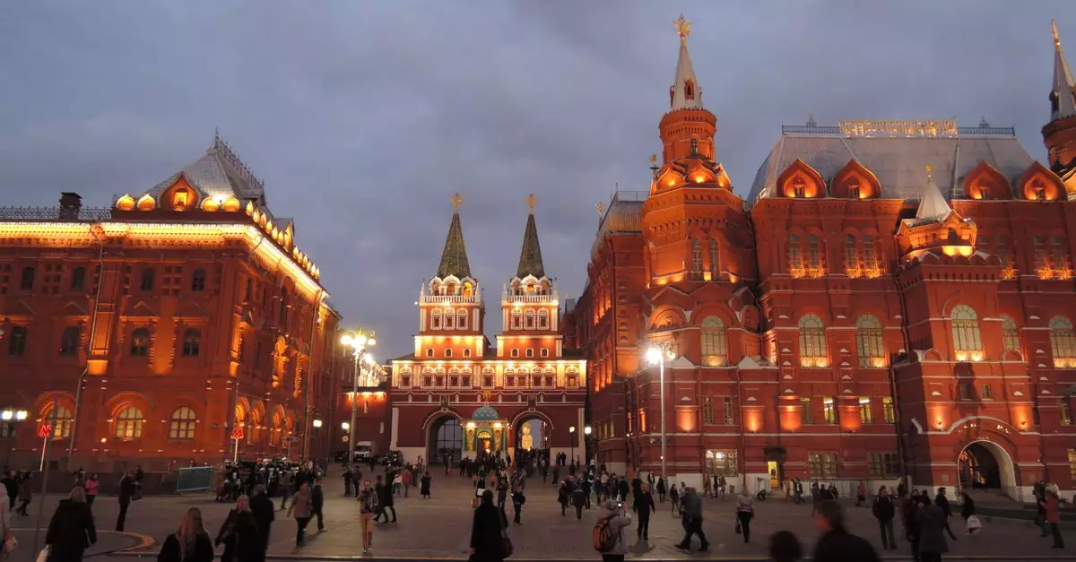 Beautiful evening view of Red Square in Moscow with a lively crowd.