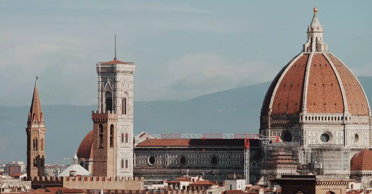 Aerial view of Florence's iconic cathedral and towers under a clear sky.