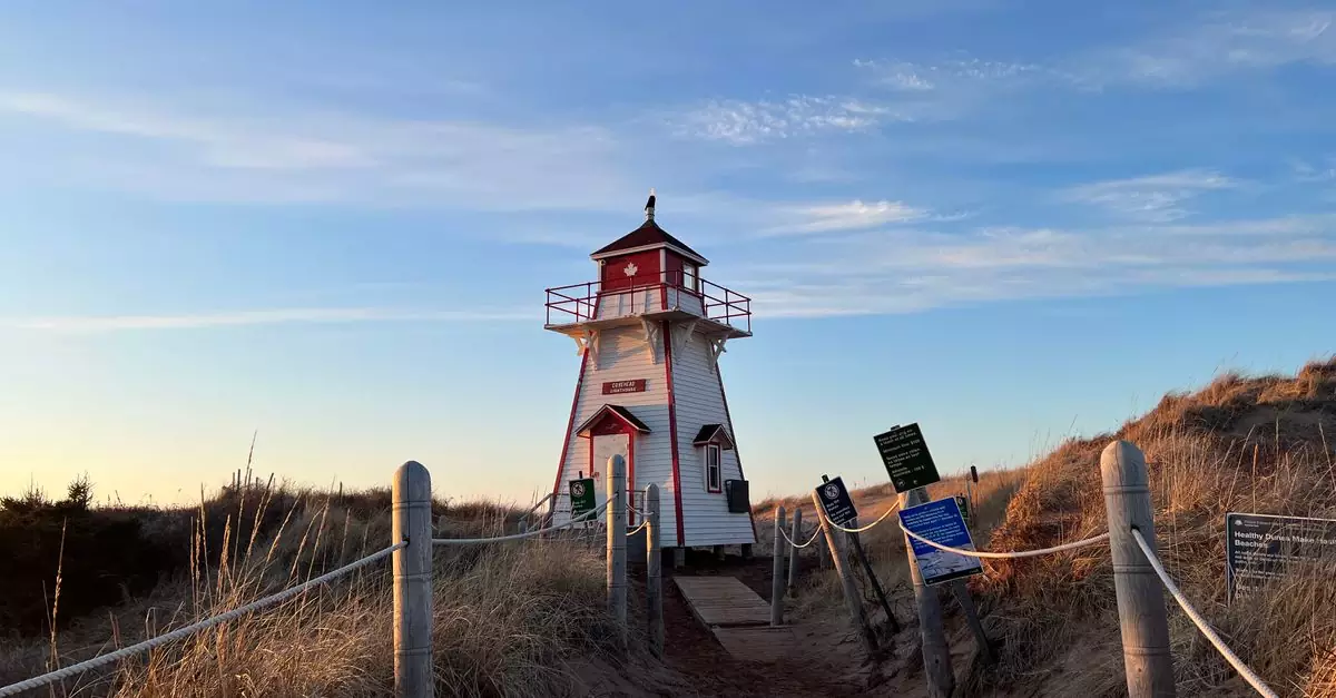 Beautiful view of Covehead Harbour Lighthouse on Prince Edward Island against a blue sky.