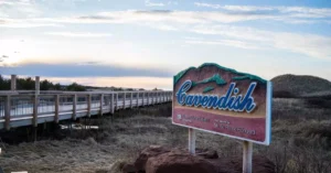 Cavendish sign by boardwalk under blue skies in Prince Edward Island, Canada.