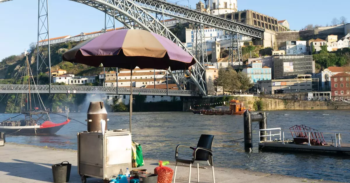 Scenic view of the Luís I Bridge in Porto with riverside street food setup.