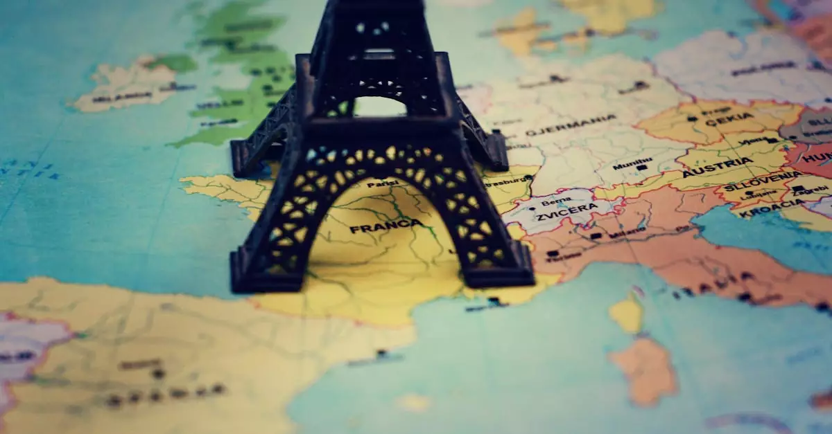 Miniature Eiffel Tower placed on a map of Europe, focusing on France.