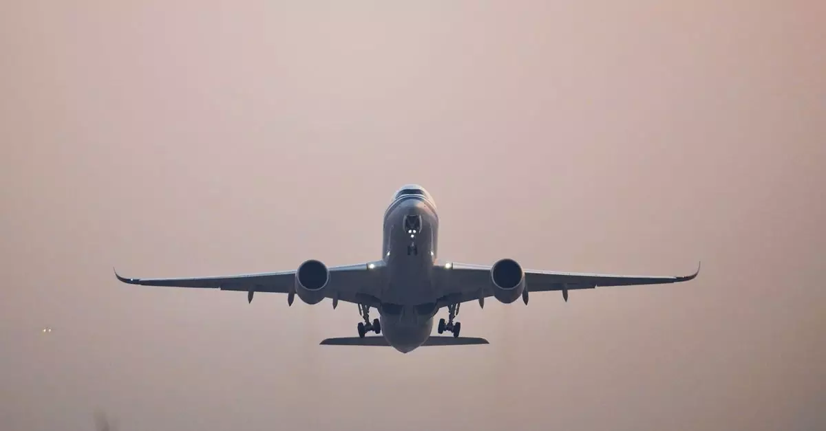 A commercial jet airplane captured in flight against a serene sunset sky.