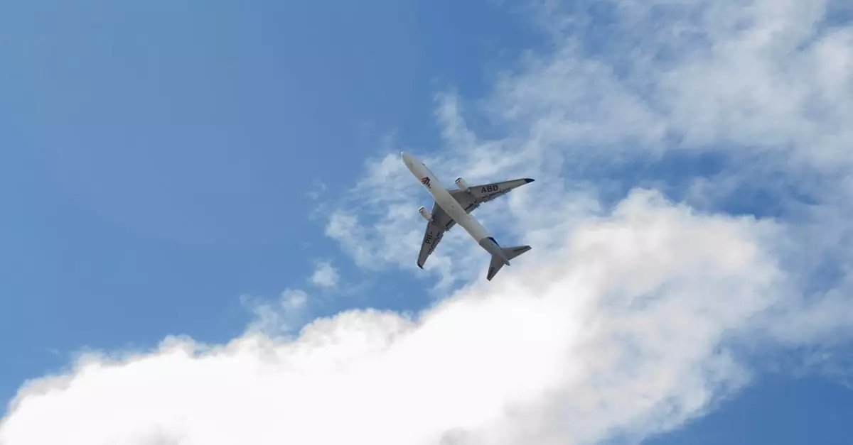 A commercial airplane soars through a bright blue sky filled with fluffy clouds, viewed from below.