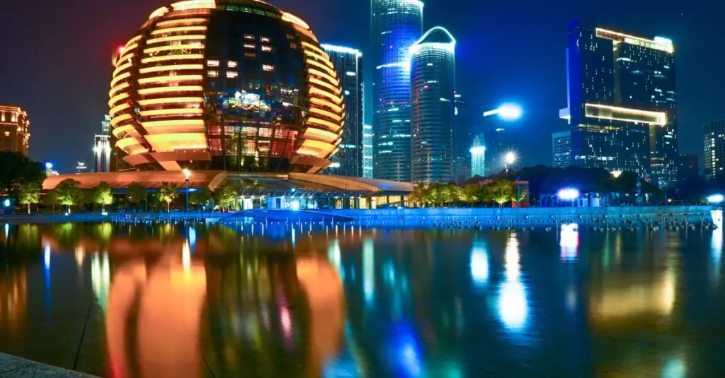Best Futuristic Travel Destinations in the Middle East 1 Stunning reflection of Hangzhou's illuminated skyline featuring modern architecture during the night.