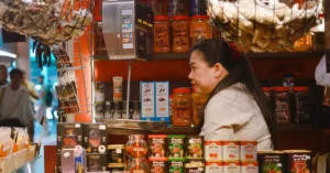 A vibrant artisan spice market stall in Barcelona, Spain, showcasing a variety of spices and food products.