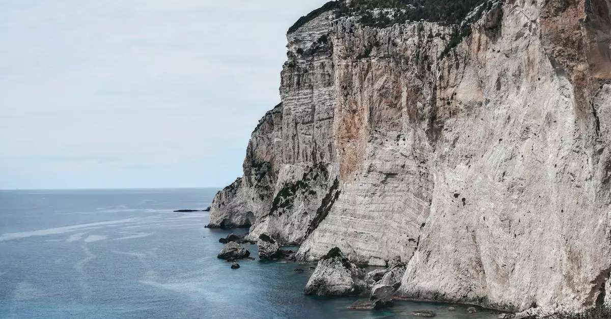 Stunning view of the steep cliffs along the coast of Gaios, Paxos, Greece under an overcast sky.