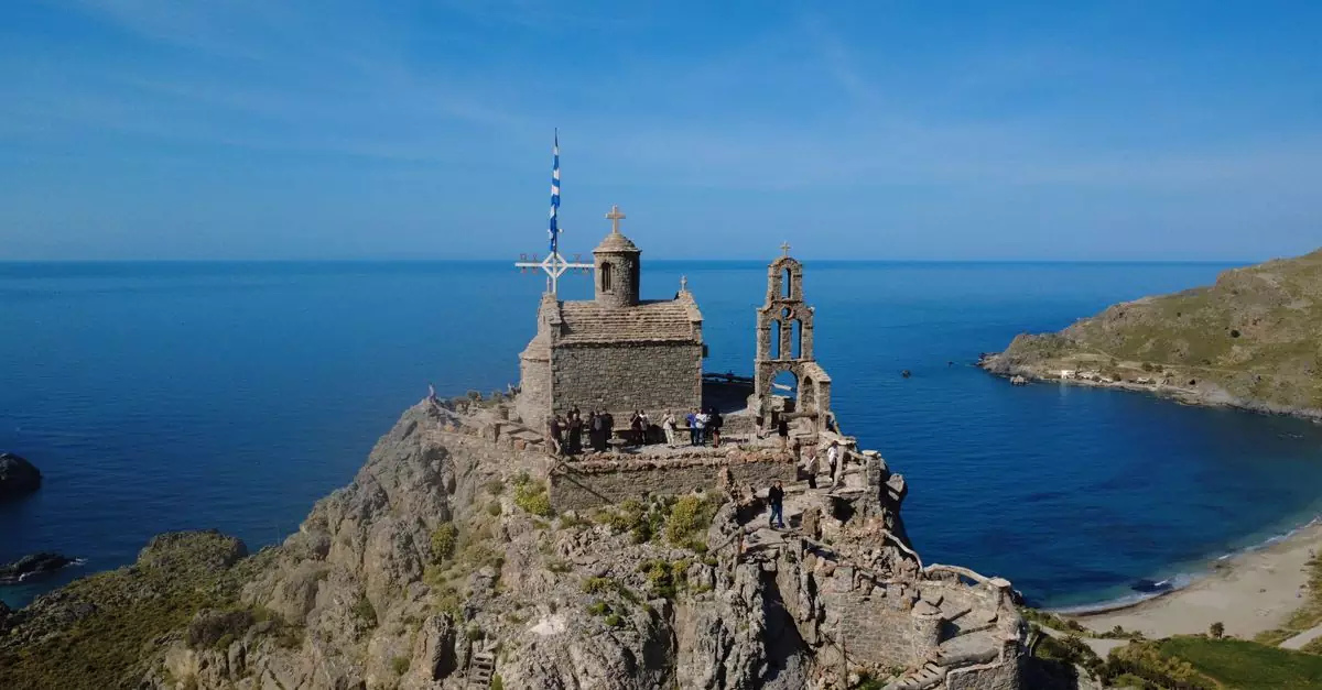 A picturesque chapel perched on a cliff with stunning views of the Plakias coastline in Greece.
