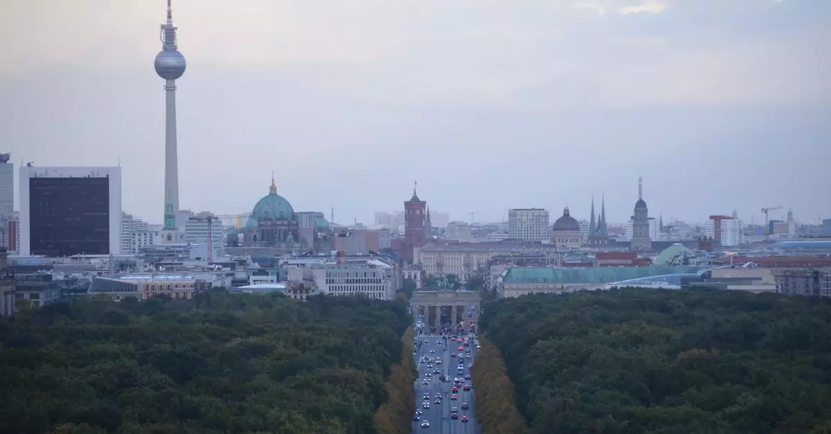 A stunning aerial view of Berlin showcasing landmarks like the TV Tower and Brandenburg Gate lined by verdant trees.