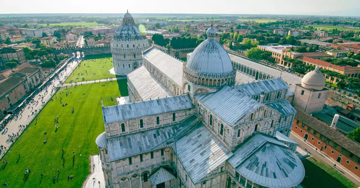 Stunning aerial view of the Pisa Cathedral and Baptistery in Italy, showcasing architectural beauty on a sunny day.