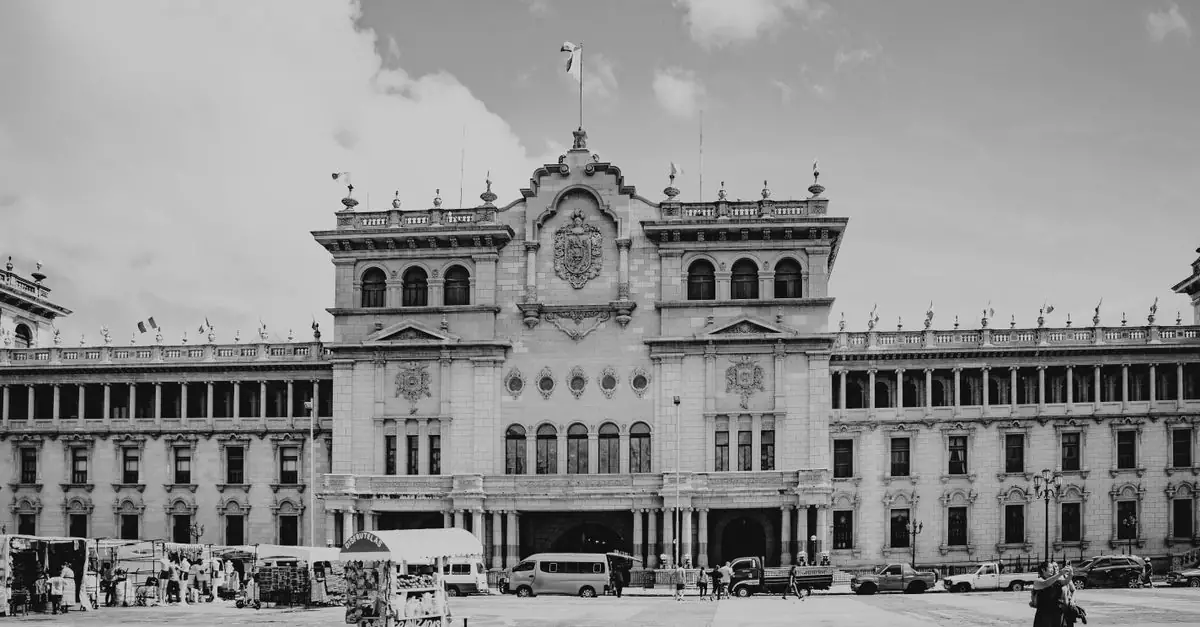 Black and white photo of the National Palace in Guatemala City, showcasing local landmarks and architecture.
