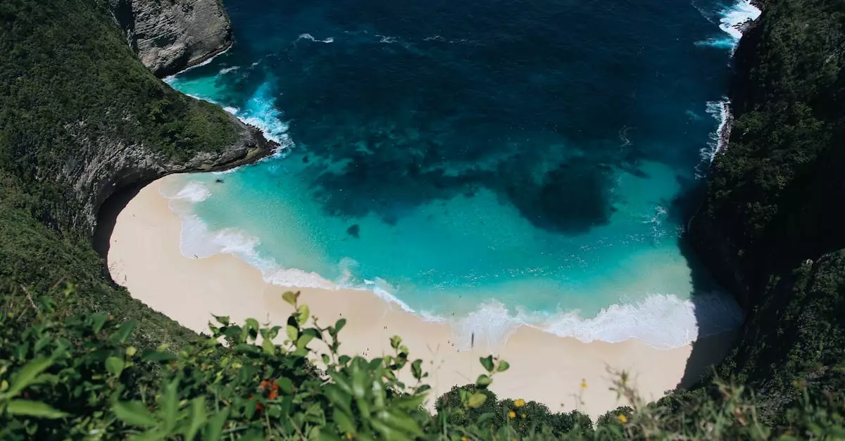 Stunning high-angle view of the turquoise waters and sandy beach at Kelingking Beach, Nusa Penida, Bali.