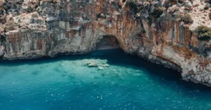 Breathtaking view of a turquoise cove with rocky cliffs in Finike, Antalya, Turkey.